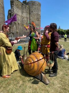picture showing a fun giant snail performing at the Festival of Ferns 2023  after parade event